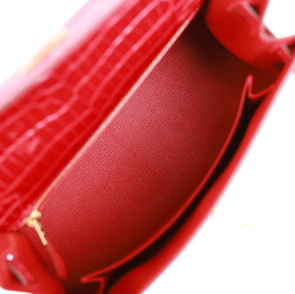 Hermès Kelly Sellier 25 Braise - Reloj de cocodrilo poroso brillante con herrajes dorados